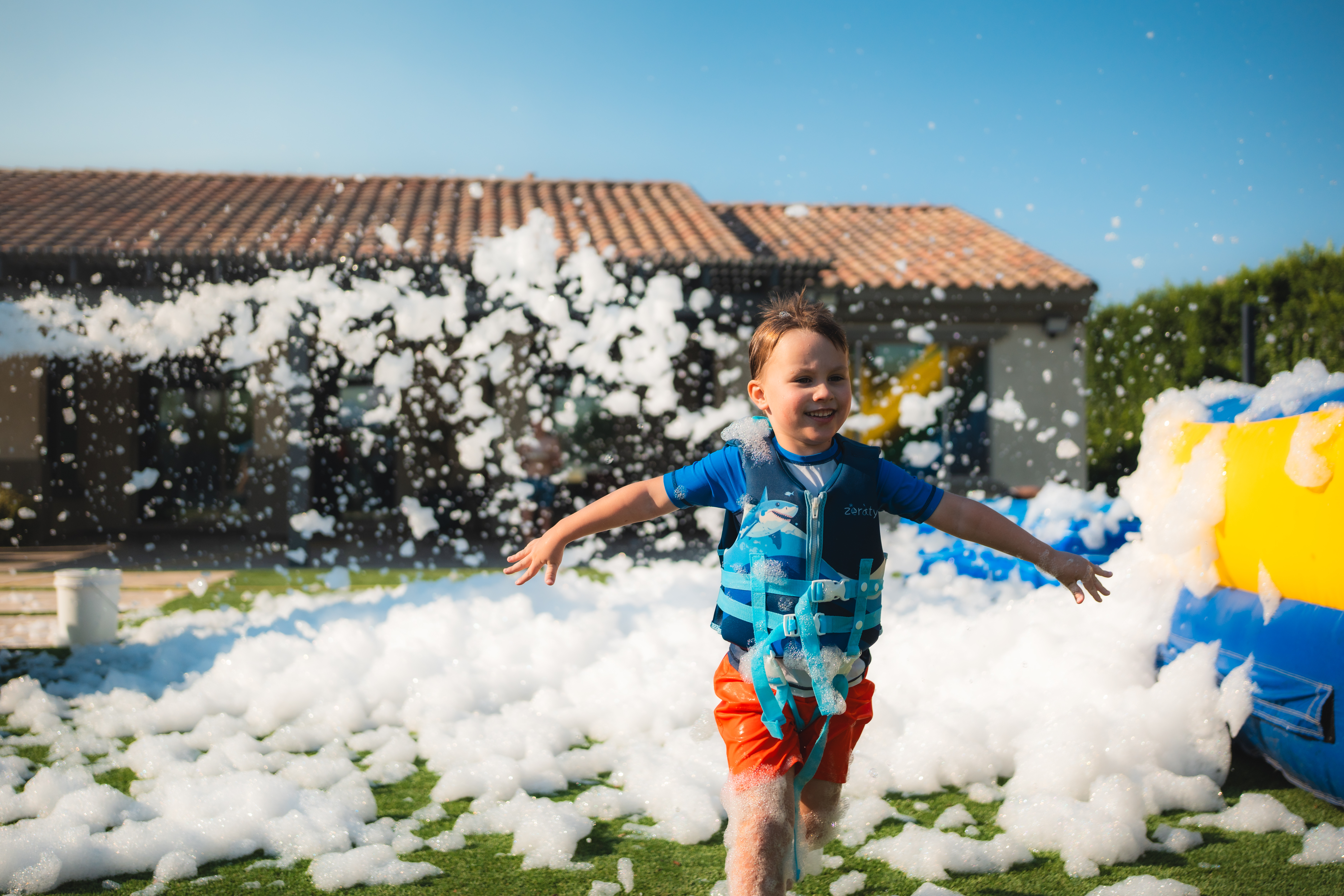 Kids playing in foam at a Phoenix Valley foam party by Party Panda Foam