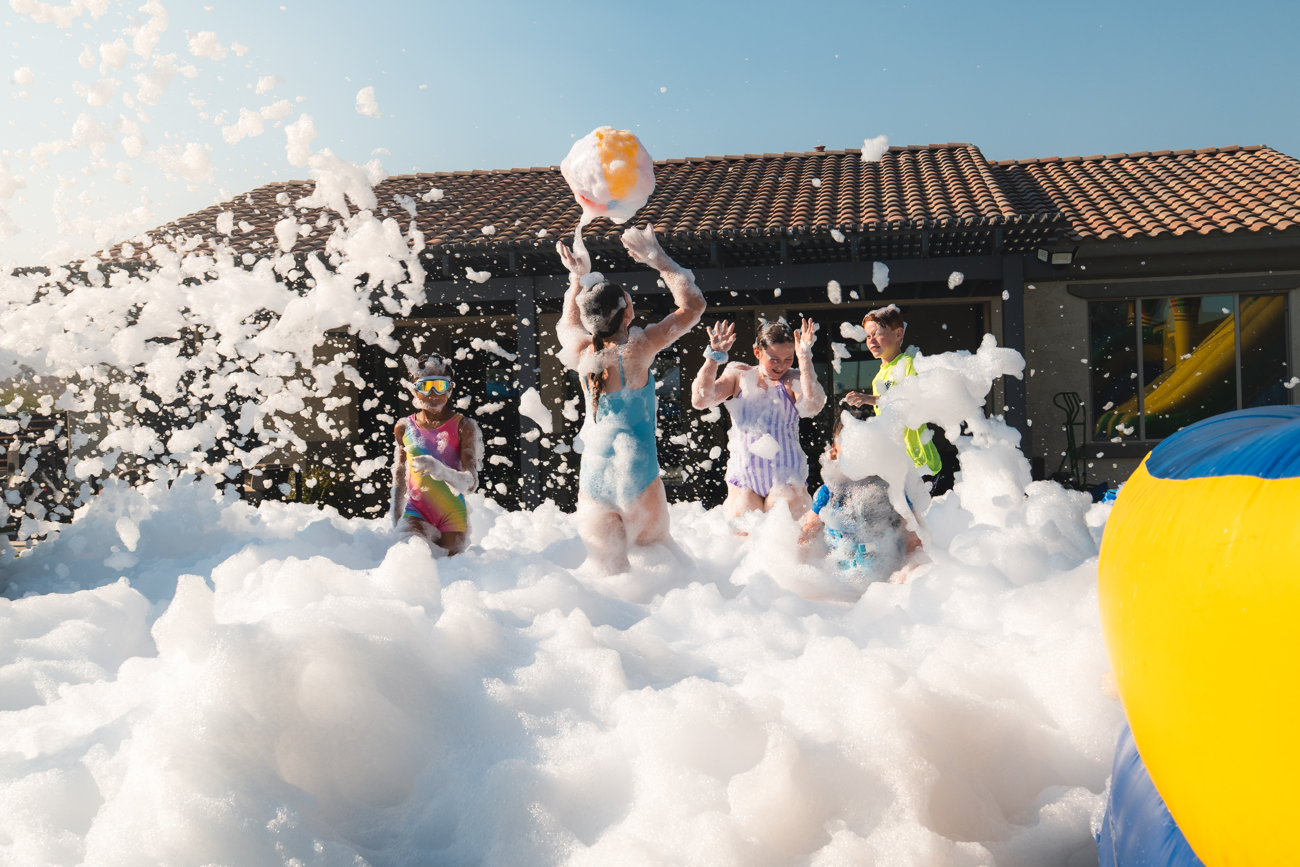 Bounce house and foam cannon setup at a Party Panda Foam event in Phoenix